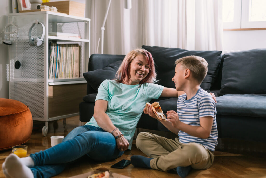 A mother and her son eating pizza together